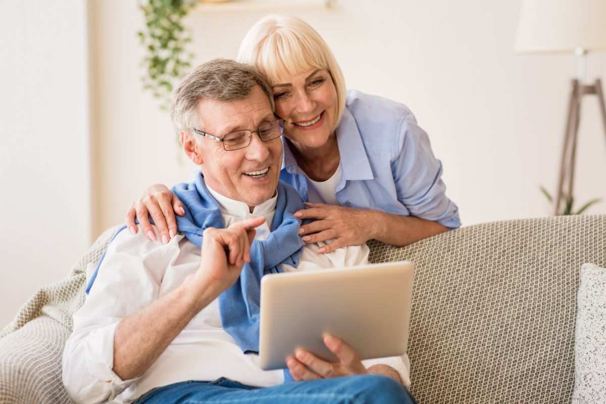 anziani felici che controllano i fondi pensione sul tablet